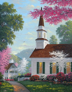 White church with steeple amid vibrant pink and white flowering trees in spring