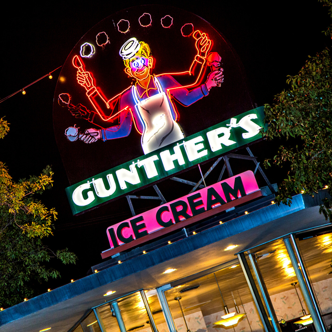 Neon Gunther’s Ice Cream sign glowing at night above a building