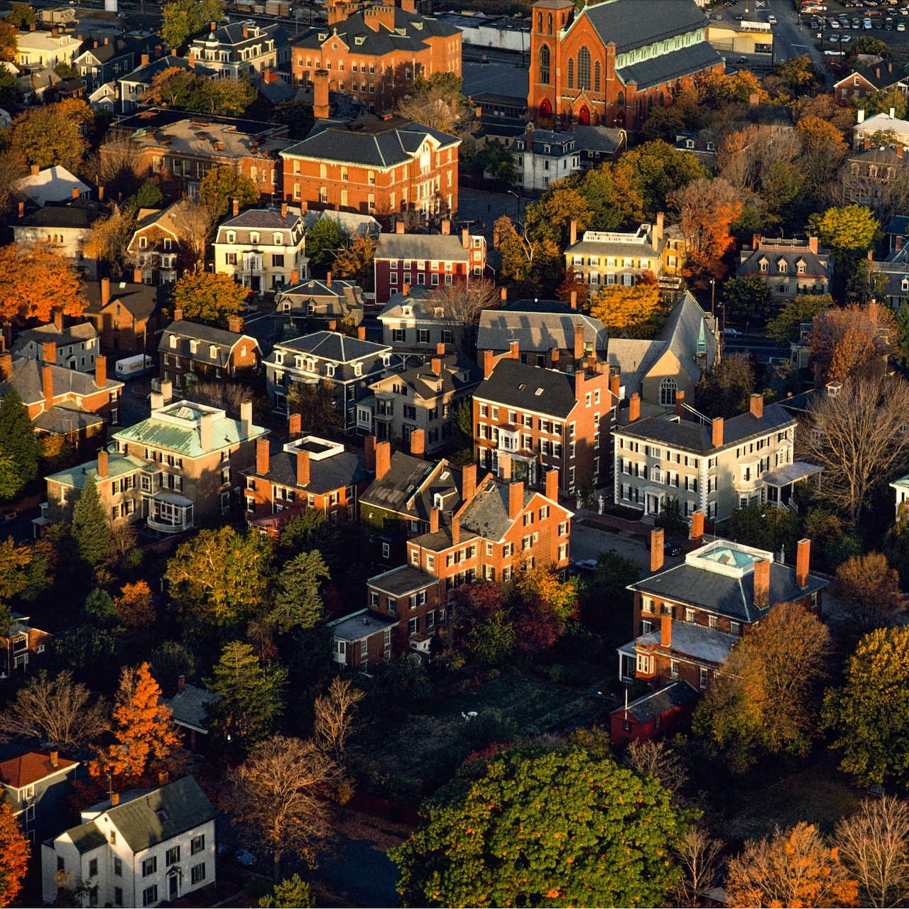 Aerial view of Salem, MA showing historic buildings and autumn trees in warm sunlight