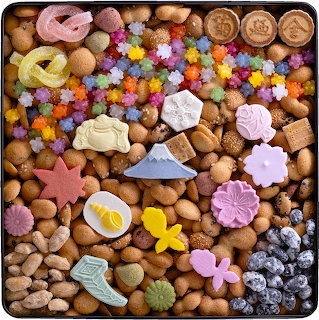 Flat lay of colorful seasonal cookies, candies, and decorated sweets in various shapes including flowers and stars