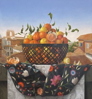 Painting of oranges in ornate basket on floral cloth with village background