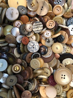 Assorted colorful sewing buttons of different sizes and materials piled together
