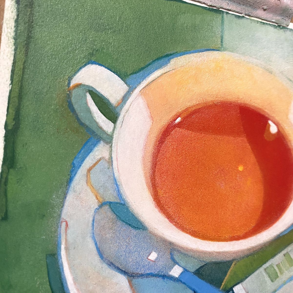Painting of a white teacup with tea on a blue saucer