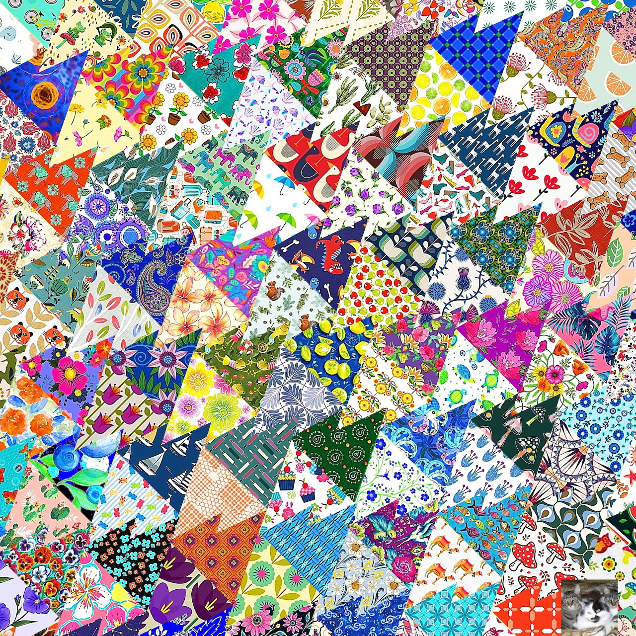 Colorful patchwork quilt made of various fabric patterns including flowers, dots, and geometric designs