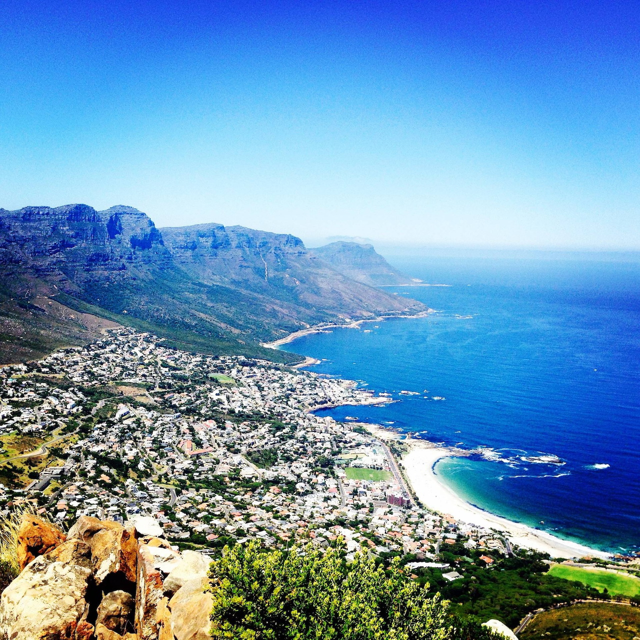 Panoramic view of Cape Town coast with Table Mountain, beaches, and turquoise ocean