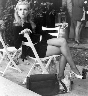 Black and white photo of woman in director's chair on film set
