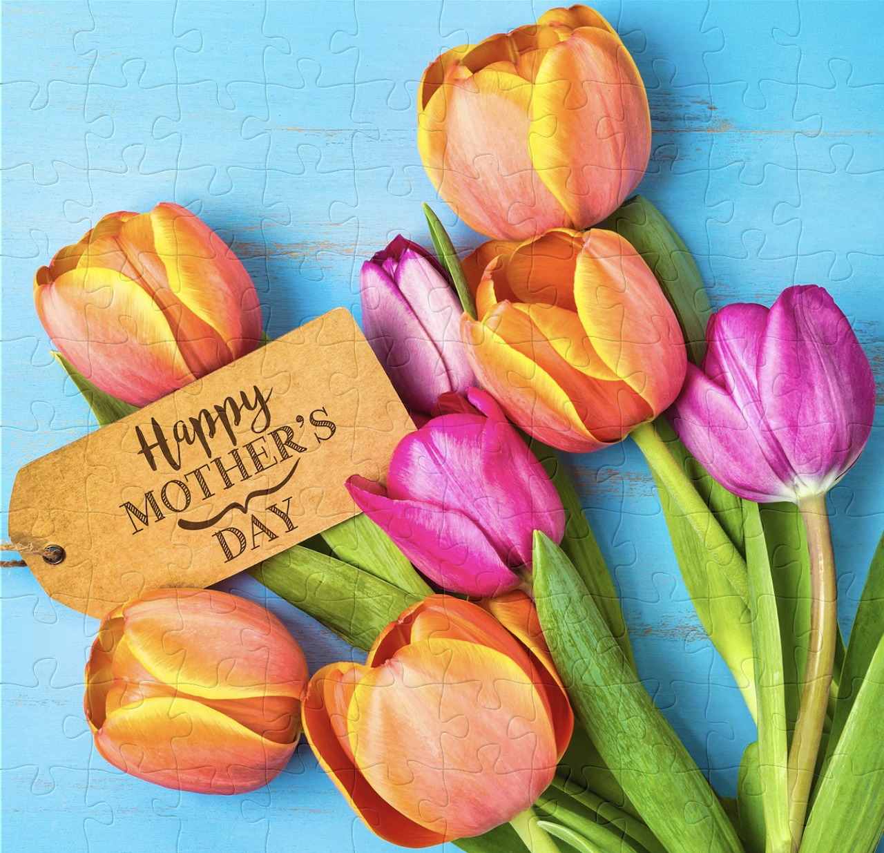 Orange and pink tulips with Mother's Day gift tag on blue background