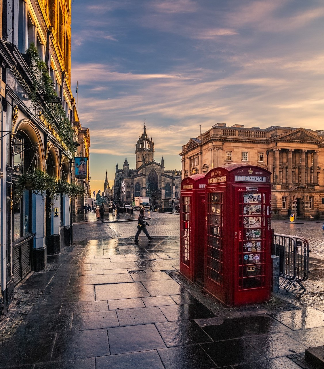 Royal Mile Edinburgh with red phone boxes and historic buildings at sunset