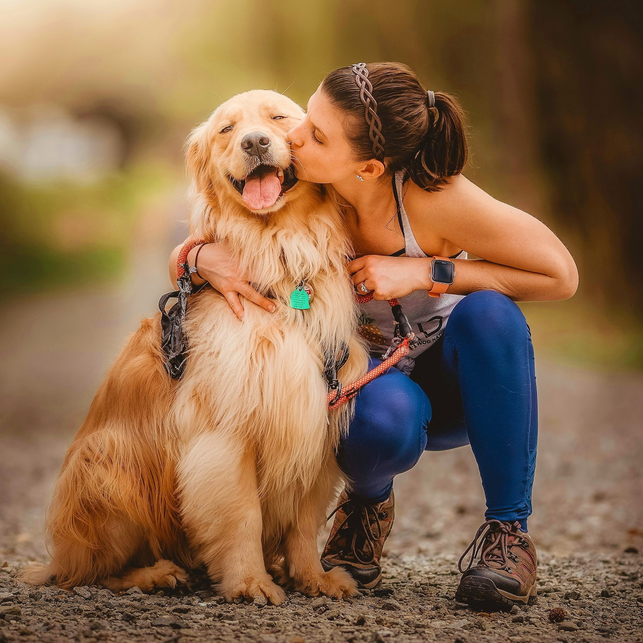 Woman Kissing Golden Retriever