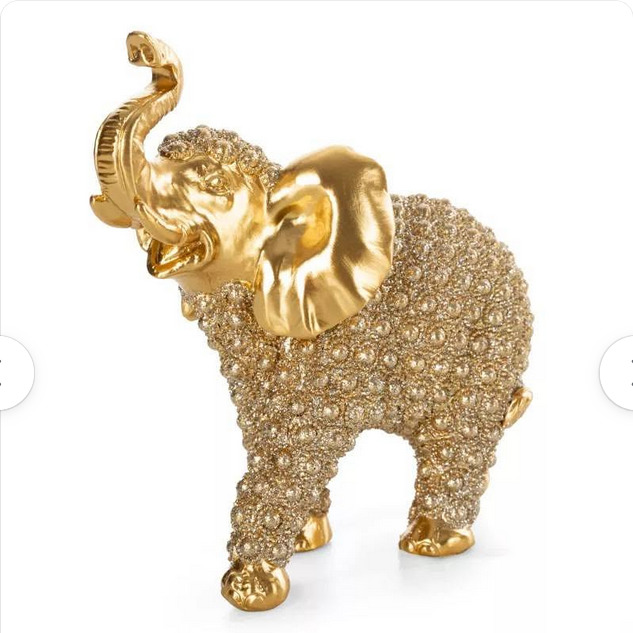 Gold elephant figurine with raised trunk on a white background