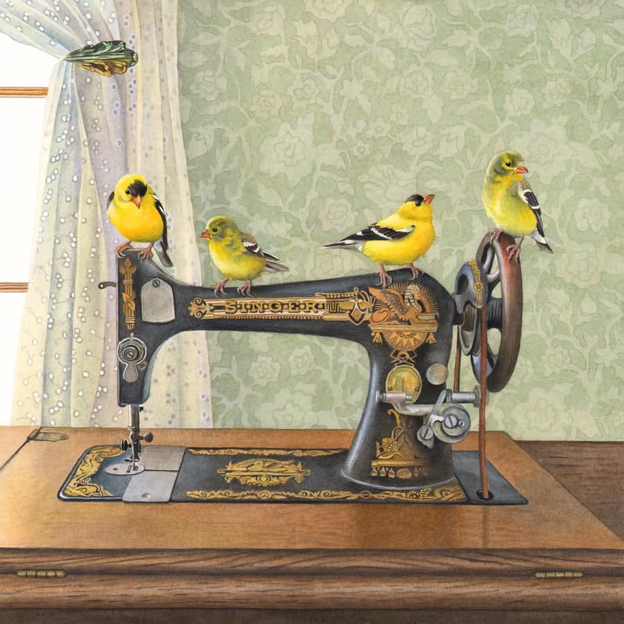 Four yellow goldfinches sitting on an old decorated sewing machine