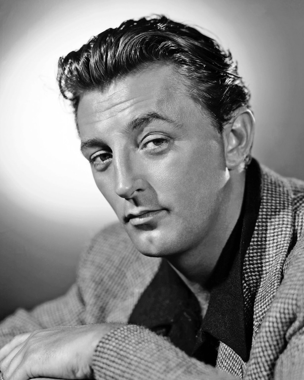 Black and white portrait of Robert Mitchum in tweed jacket looking at camera