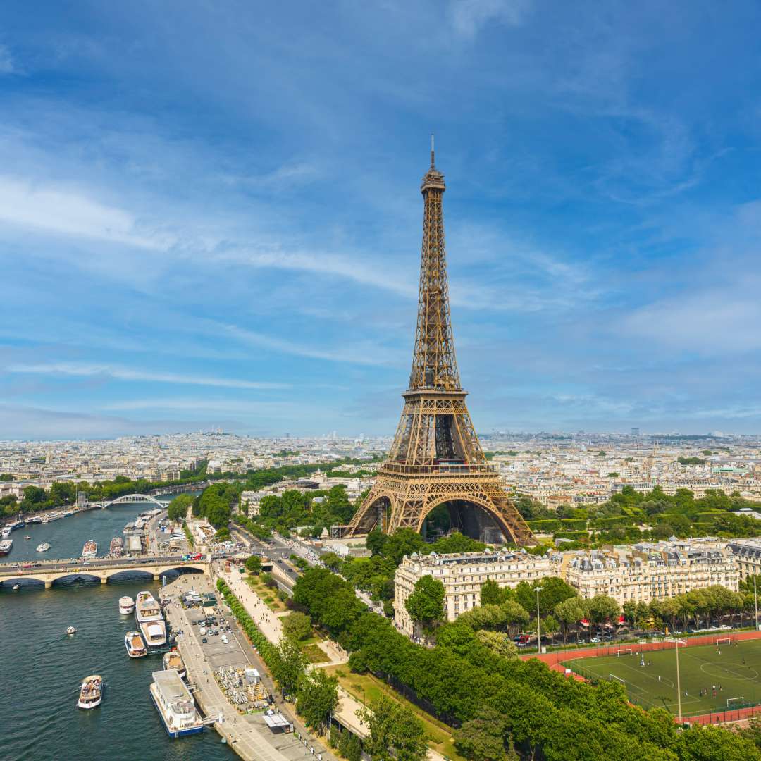 Aerial view of the Eiffel Tower in Paris beside the Seine River and city buildings
