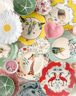 Overhead view of decorative plates with animal and floral motifs on yellow background