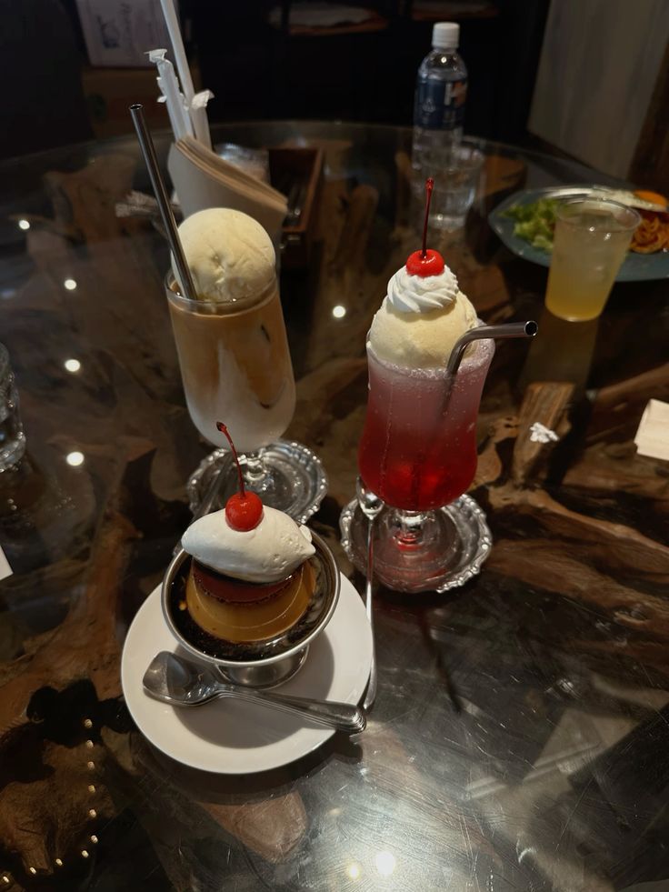 Japanese cream soda float with cherry, custard pudding, and cafe latte on a table