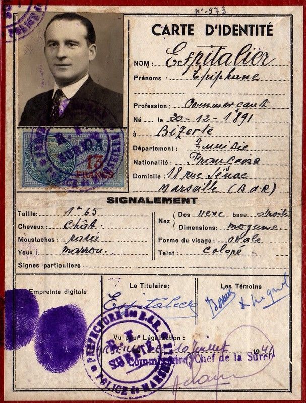 Vintage French identity card with portrait photo, handwritten text, and official stamps