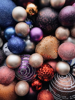 Colorful Christmas ornaments in various textures including glitter, matte and metallic finishes