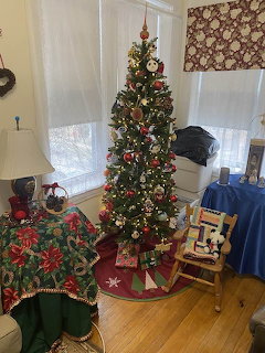 Decorated Christmas tree in a cozy room with gifts and holiday decorations