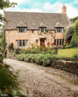 Stone cottage with thatched roof and garden