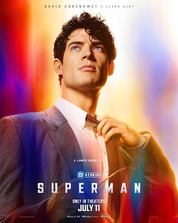 Superman movie poster showing Clark Kent in a suit against a glowing red, blue, and gold background.