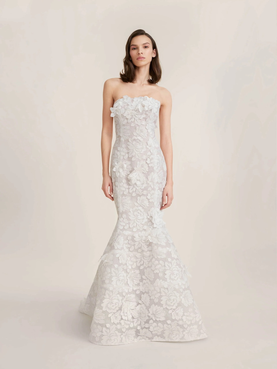 Model in strapless white lace mermaid wedding dress with floral details