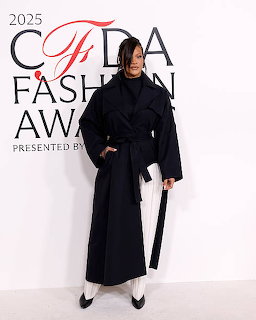 Rihanna in an oversized navy belted coat at the 2025 CFDA Fashion Awards step-and-repeat backdrop
