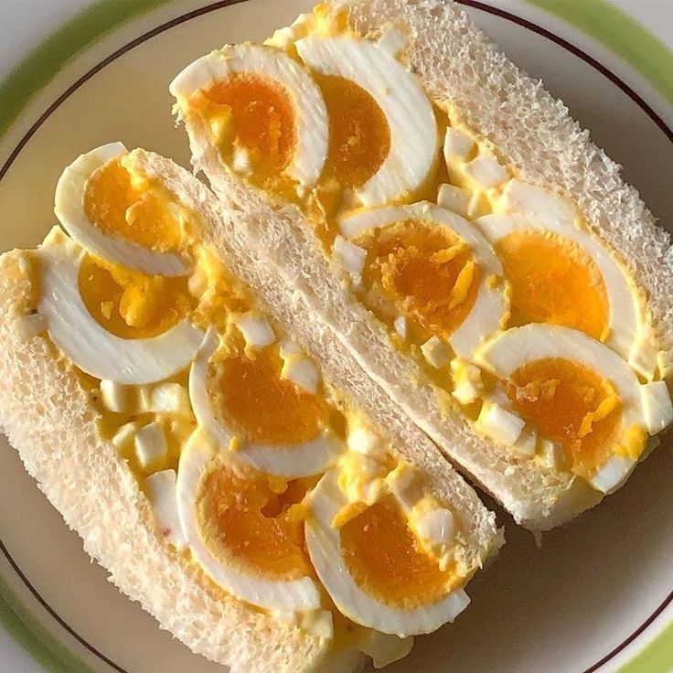 Japanese egg sandwich with soft-boiled egg slices and orange yolks on white bread