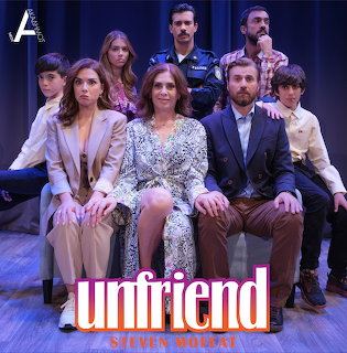 Cast poster for Unfriend with seven people posed on a stage in front of blue curtains