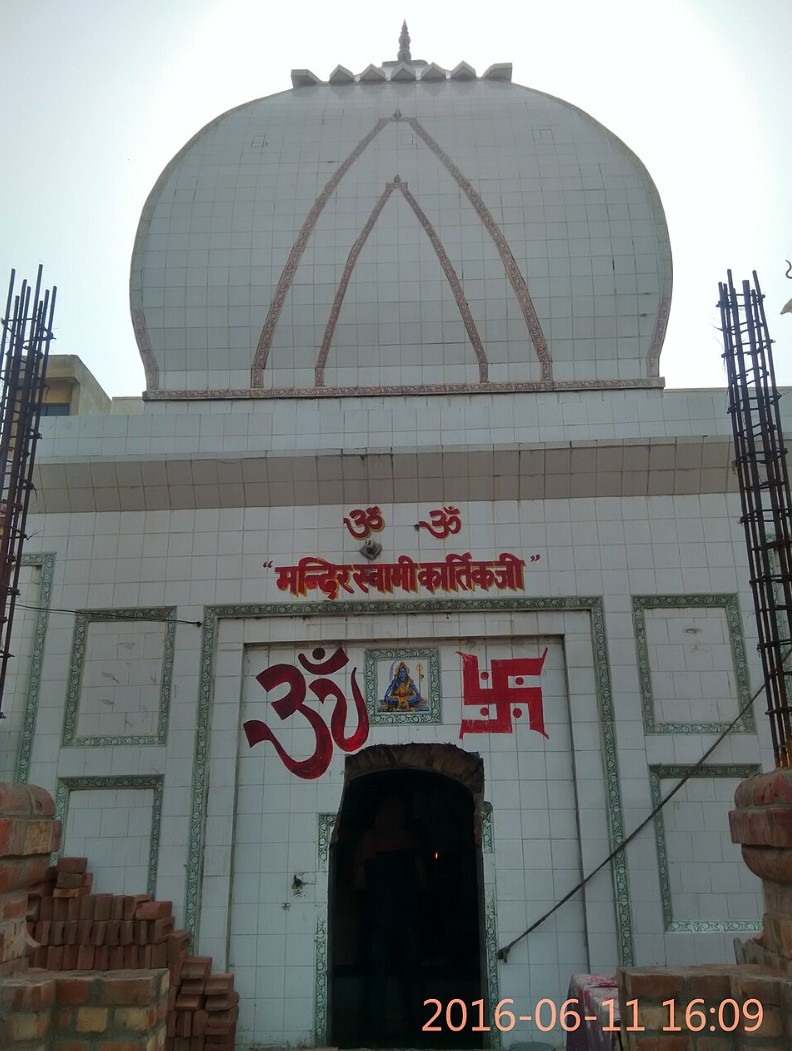 Front view of Kartikeya Temple with a large dome and Hindu symbols over the entrance