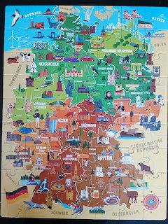 Colorful illustrated map of Germany with landmarks, cities, and cultural icons in cartoon style