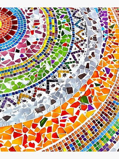 Circular mosaic mandala with rainbow colored tiles in geometric patterns radiating outward