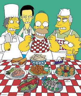 The Simpsons characters standing behind a checkered table filled with dishes of food