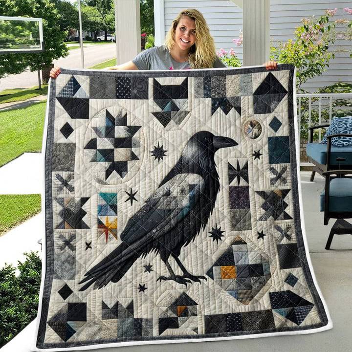 Woman holding quilted blanket with large black crow design and geometric star patterns in grayscale