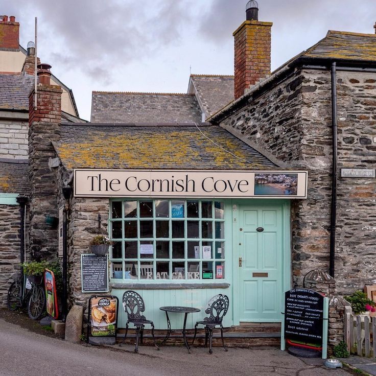 Stone-fronted shop with mint green door and The Cornish Cove sign
