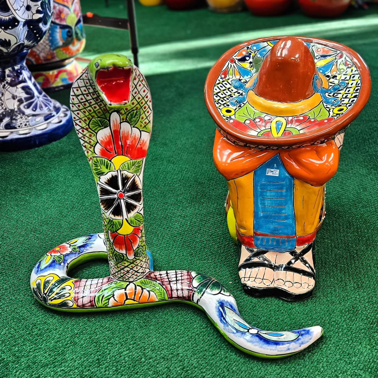 Brightly painted Talavera ceramic cobra and sombrero figure with traditional Mexican folk art patterns