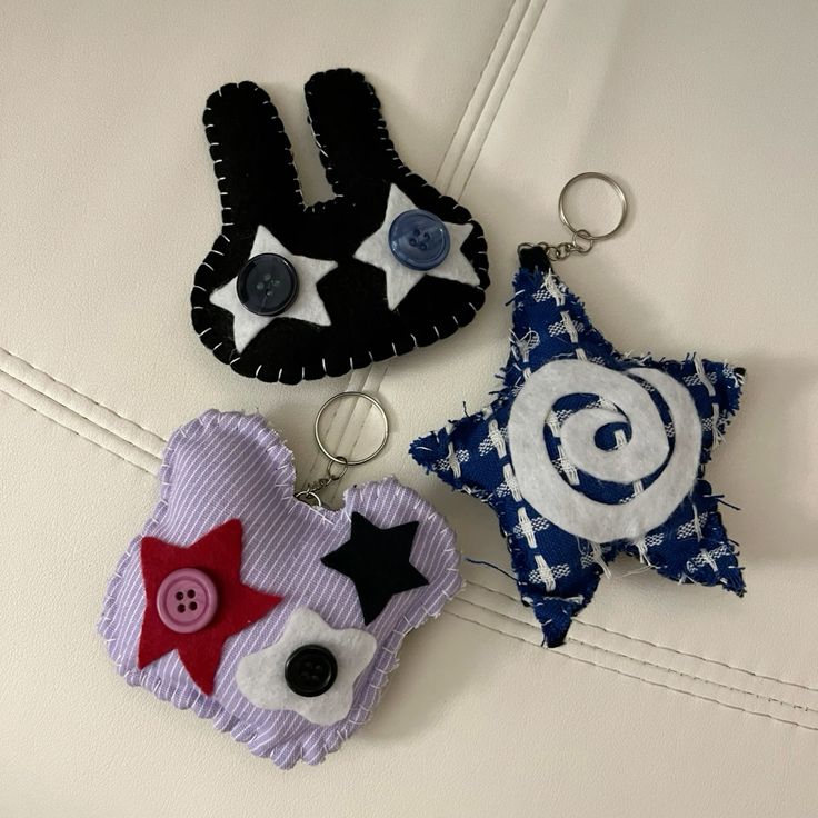 Three decorative felt keychains in bunny, owl, and star shapes with hand-stitched details
