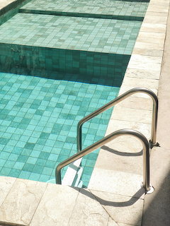 Overhead view of swimming pool with handrail and tiled deck