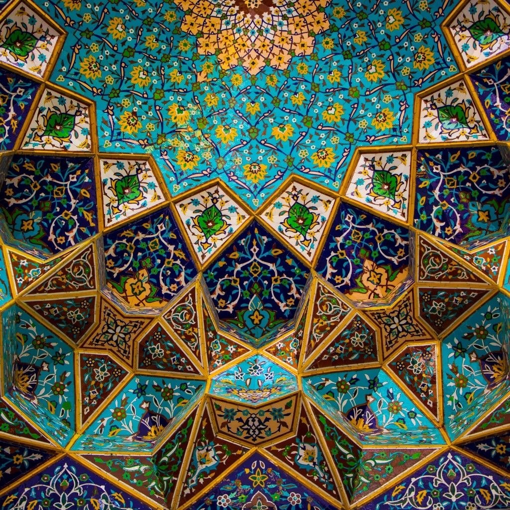 Ornate Islamic geometric tile pattern with turquoise, gold and blue colors in radial symmetry
