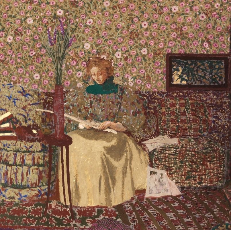 Painting of a woman reading in a patterned room with floral wallpaper, textiles, and flowers