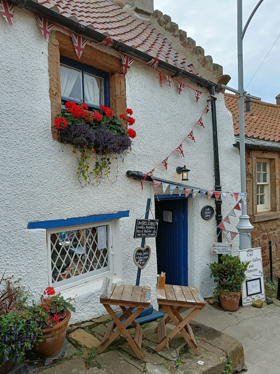 White cottage cafe with bunting and flower boxes in Crail, Scotland