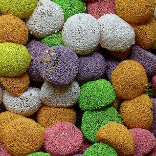 Close-up of assorted colorful round sweets coated in tiny sugar beads