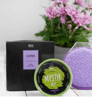 Greenway ULTRA and MYSTIK cosmetic products displayed with pink flowers and purple towel