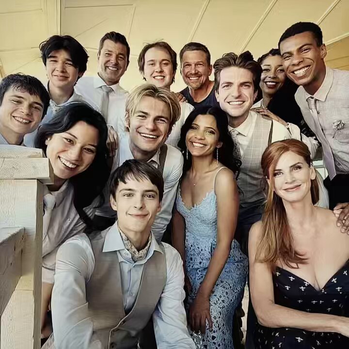 Group of smiling young adults posing together indoors for a portrait