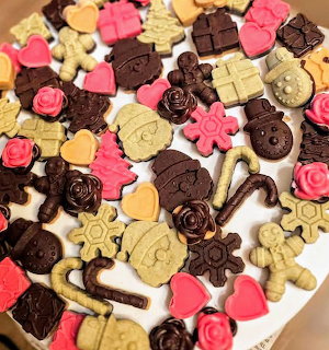 Assorted winter cookies and chocolates with heart, flower, gingerbread, and candy cane shapes
