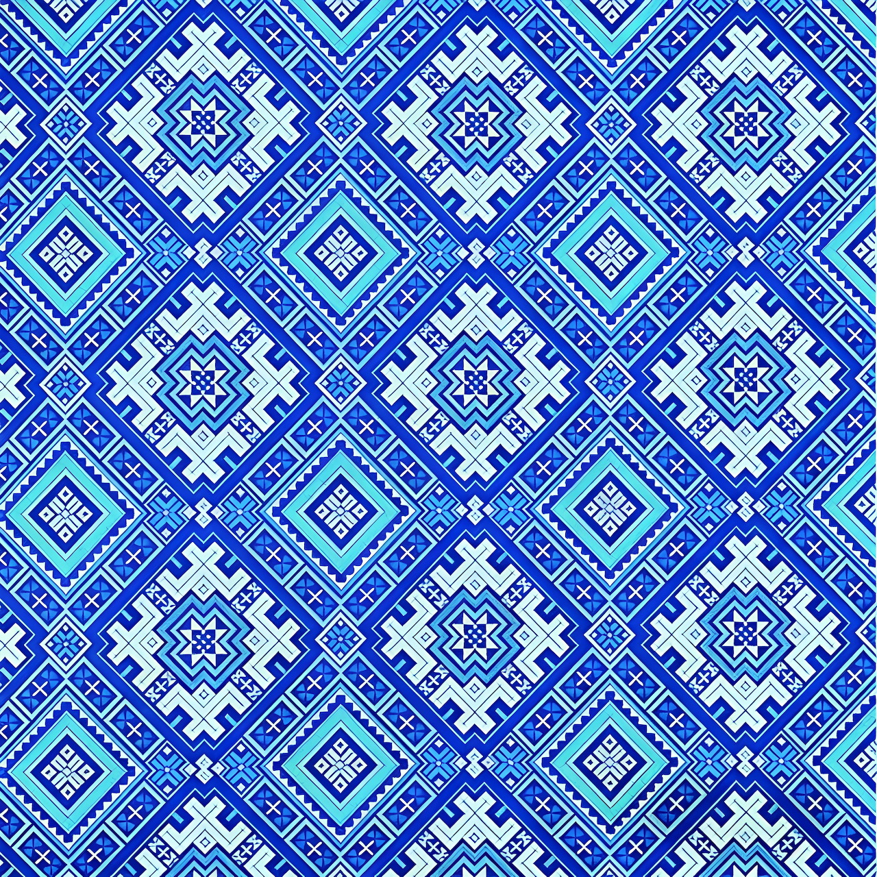 Repeating blue and white geometric diamond pattern with traditional textile design elements