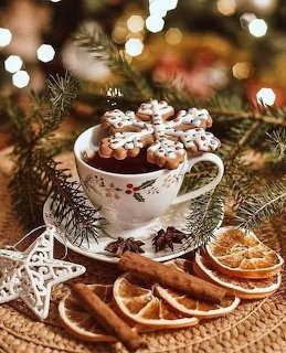 Gingerbread cookies in festive cup with pine branches, dried oranges, and cinnamon sticks on rustic burlap