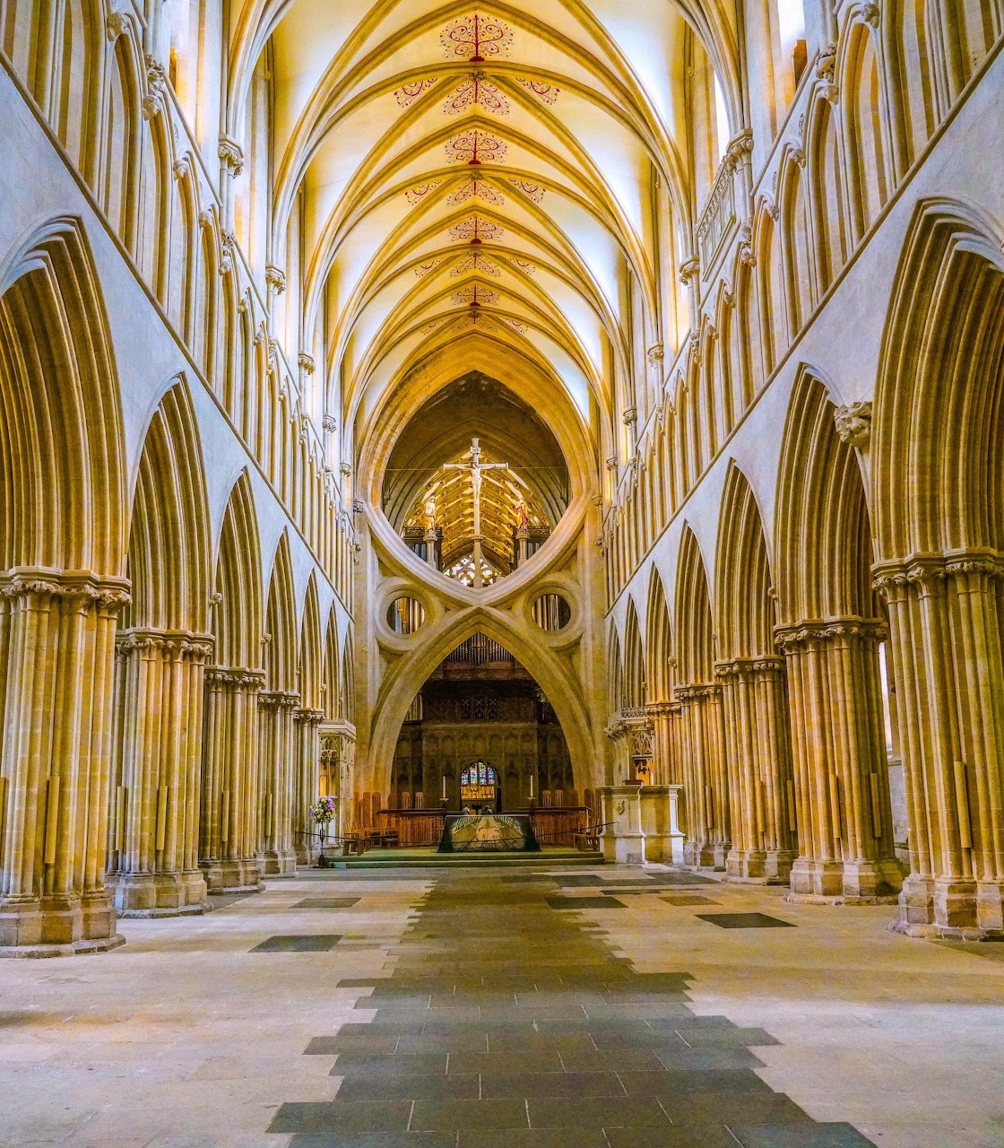 Gothic scissor arches inside Wells Cathedral with stone vaulting and tall nave