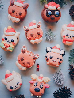 Colorful macarons decorated as Pokémon characters with Santa hats and Christmas themed details on white background
