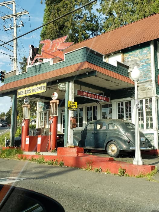 Vintage Mobil gas station with antique red pumps and a classic 1940s car parked under a retro canopy