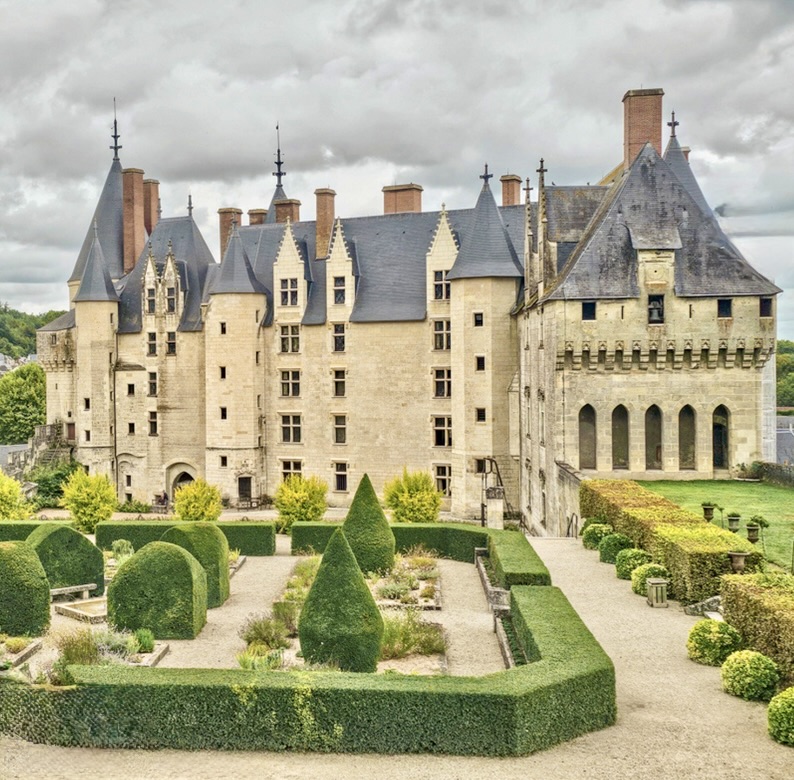 Chateau de Langeais medieval castle with towers and formal gardens under cloudy sky